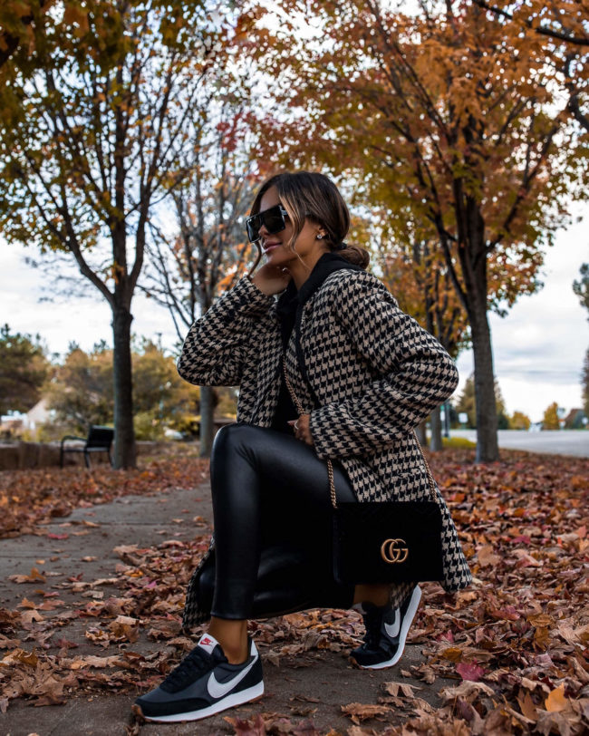 fashion blogger wearing nike sneakers and a houndstooth blazer