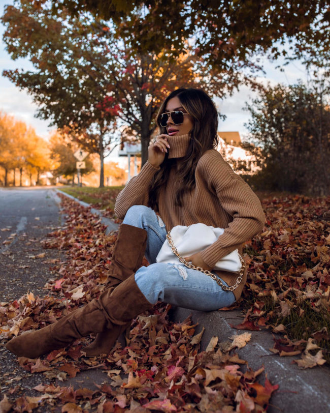 fashion blogger mia mia mine wearing suede boots from walmart and a chunky knit turtleneck sweater