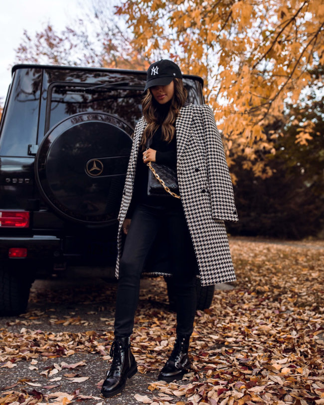 fashion blogger wearing a louis vuitton coussin bag in black