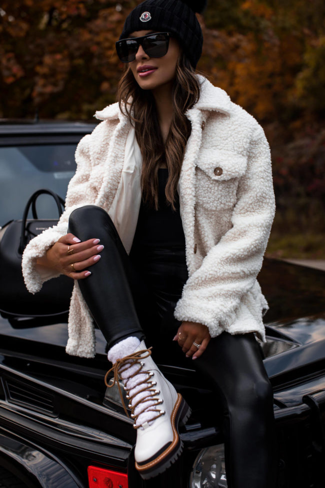 fashion blogger wearing white shearling boots by marc fisher