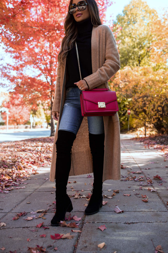 fashion blogger wearing over the knee boots and a camel duster cardigan