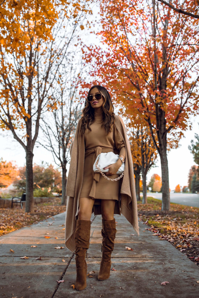 fashion blogger mia mia mine wearing a camel sweater dress and brown suede boots for fall