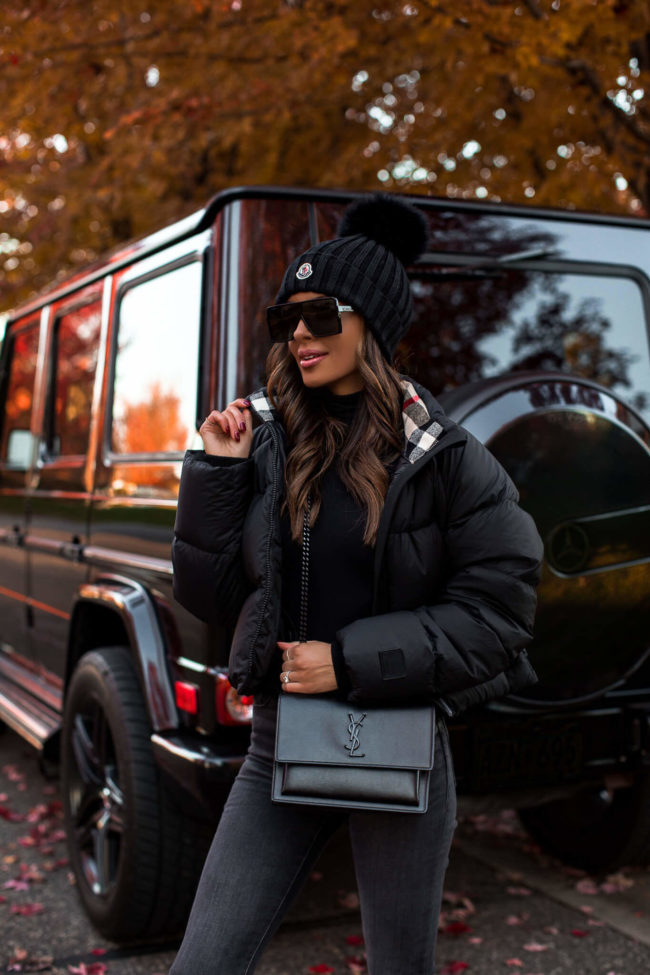 fashion blogger wearing a burberry puffer jacket and a moncler beanie