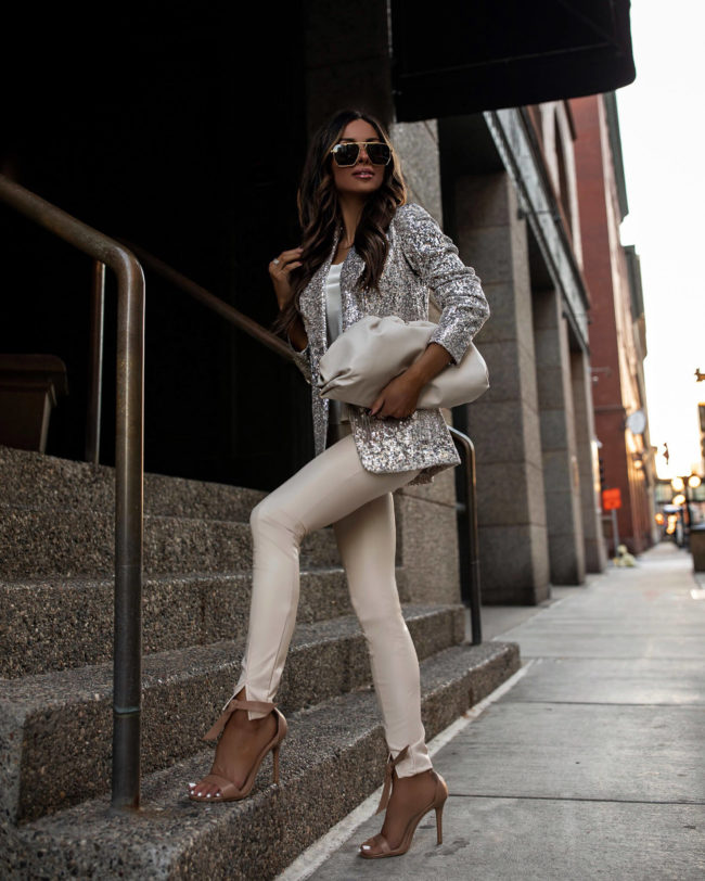fashion blogger mia mia mine wearing faux leather pants and a sequin blazer from express