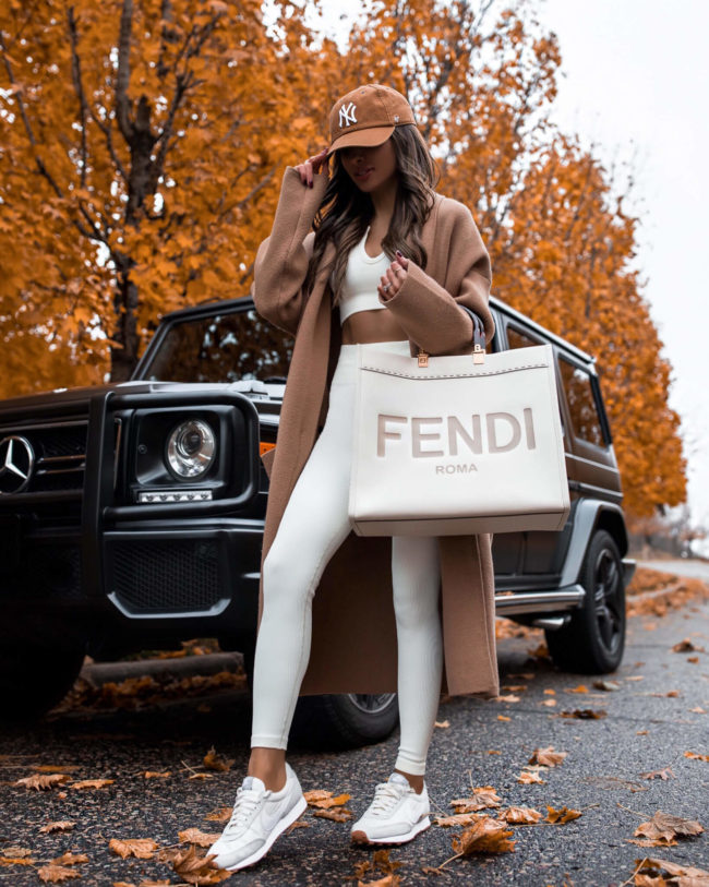 fashion blogger mia mia mine wearing an olive green knit set from amazon and white nike daybreak sneakers