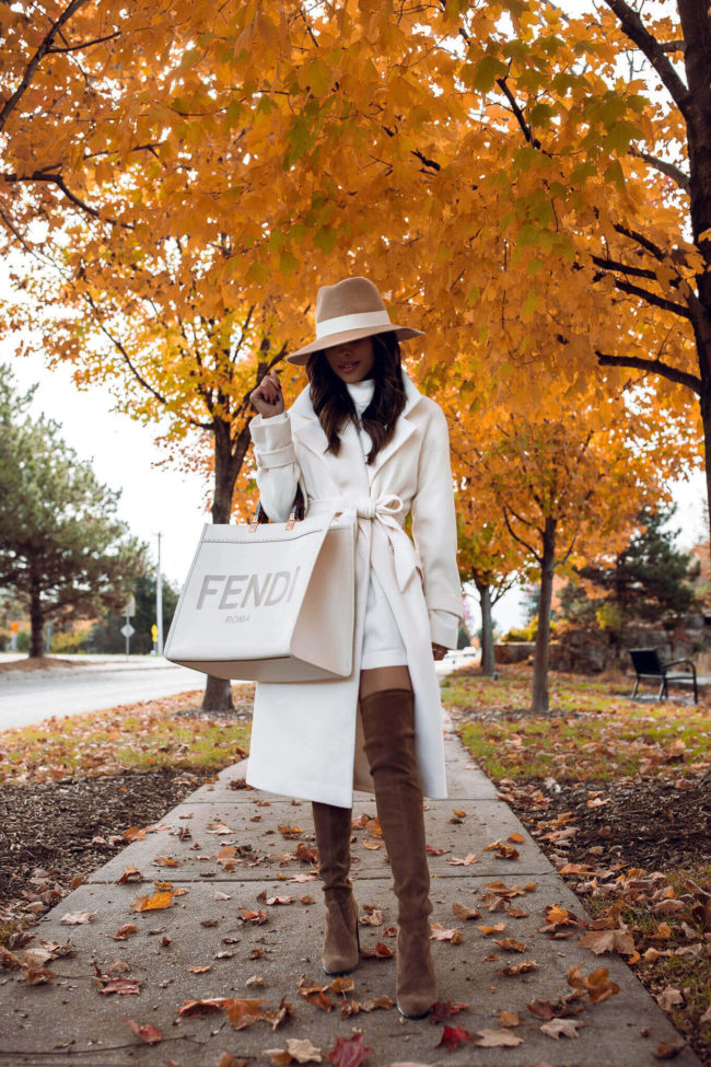 fashion blogger wearing an express wrap coat and fendi sunshine tote