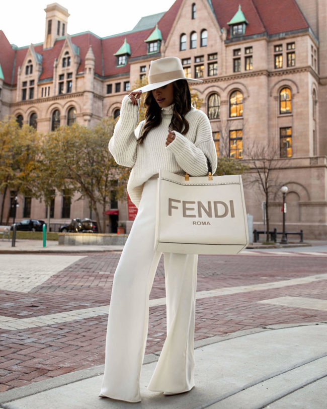fashion blogger wearing a winter white outfit with a fendi sunshine tote
