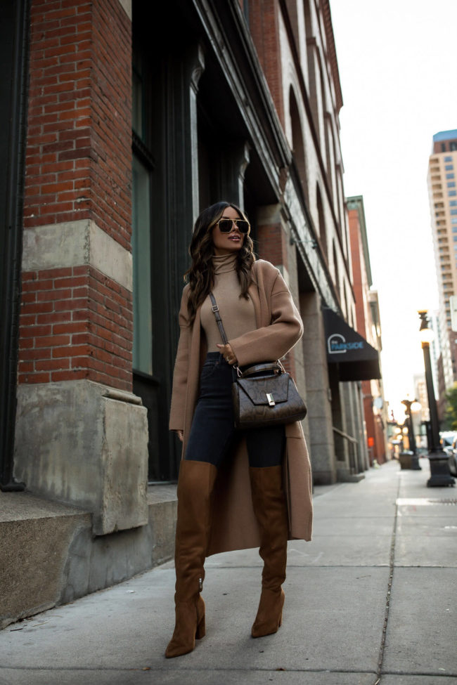fashion blogger wearing a camel coatigan with nine west over the knee boots