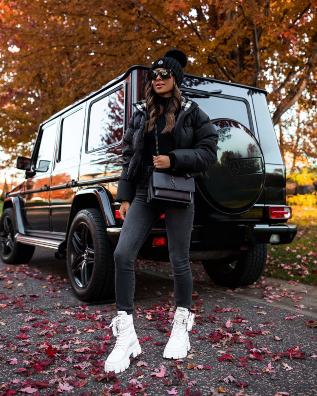 fashion blogger mia mia mine wearing a burberry puffer jacket and a moncler beanie