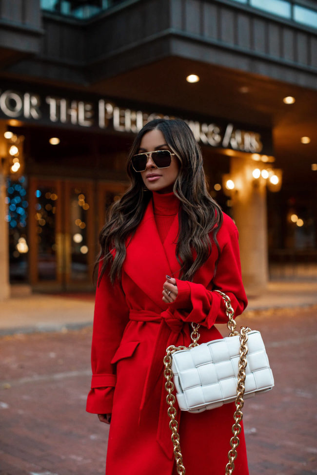 fashion blogger mia mia mine wearing a red coat from express