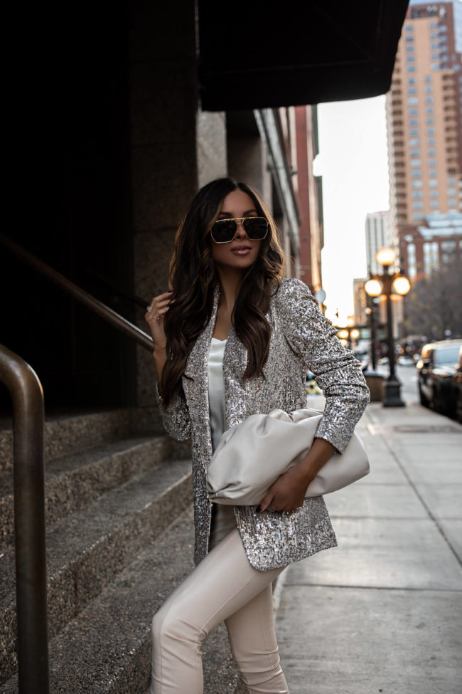 brunette fashion blogger wearing a sequin blazer and faux leather pants from express