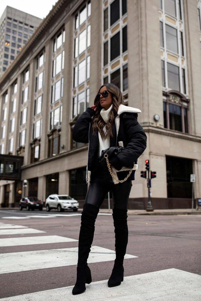 fashion blogger mia mia mine wearing a sherpa jacket from walmart with faux leather leggings