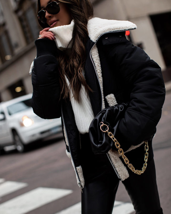 fashion blogger wearing a shearling jacket and pouch bag from walmart