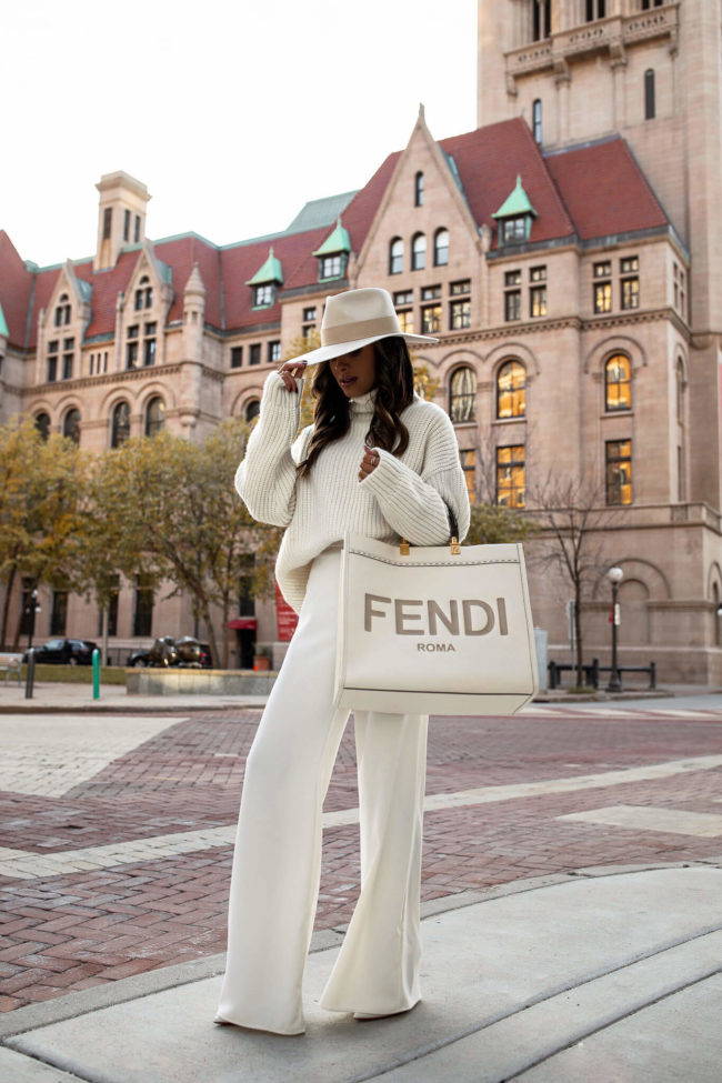 fashion blogger mia mia mine wearing a white anine bing sweater with white wide leg pants for fall