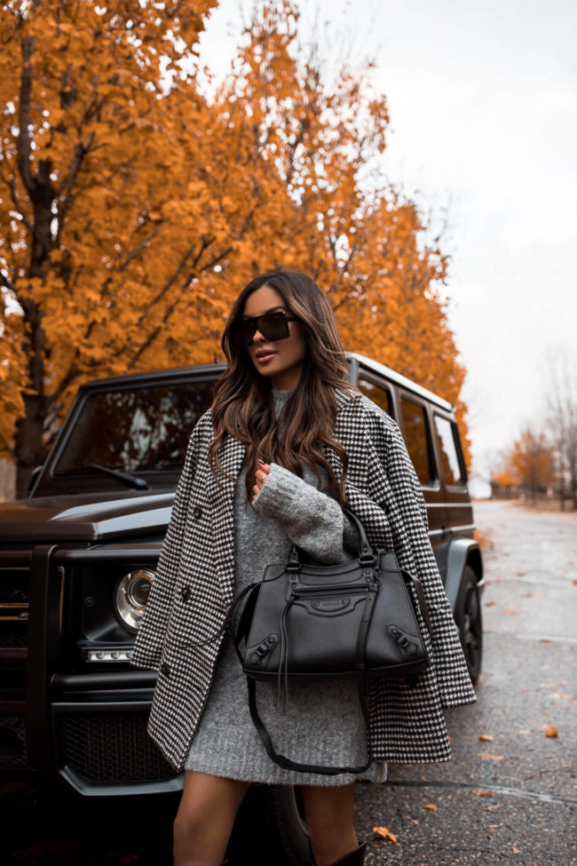 fashion blogger wearing a houndstooth coat and gray sweater dress
