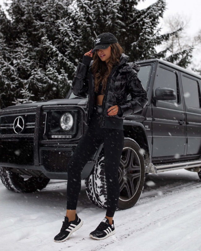 fashion blogger mia mia mine wearing a puffer jacket and adidas sneakers
