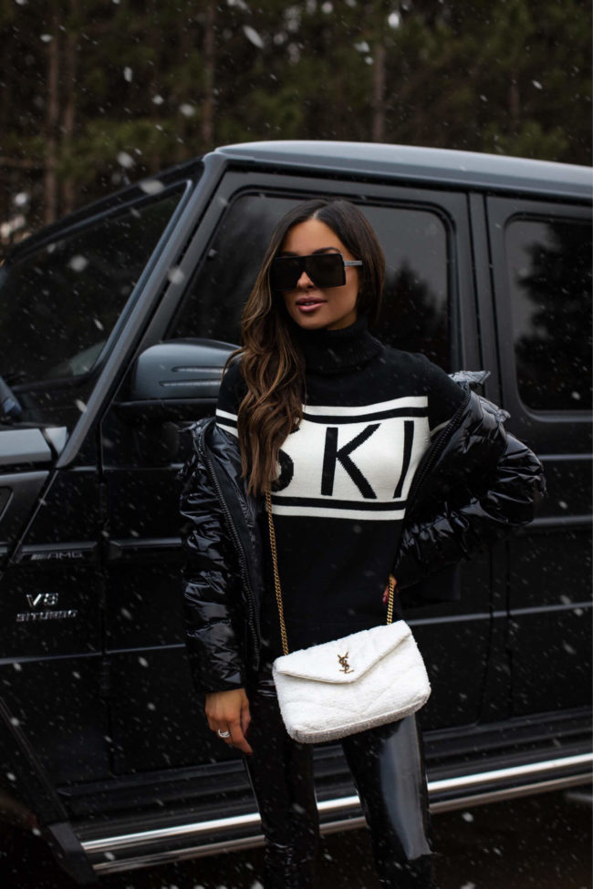 fashion blogger mia mia mine wearing a winter ski outfit from saks