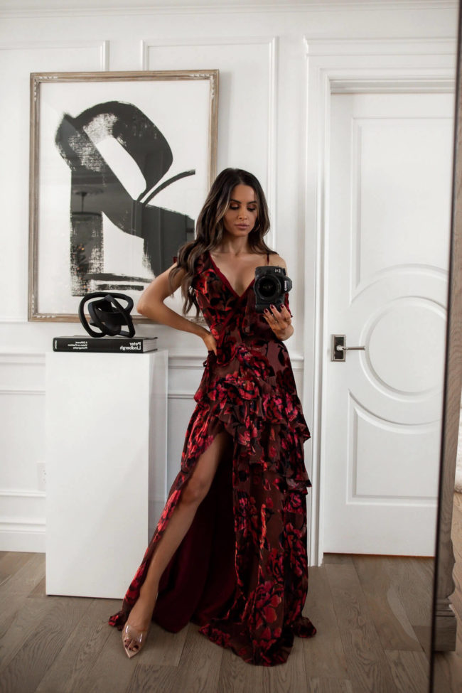 fashion blogger wearing a red floral dress from rent the runway