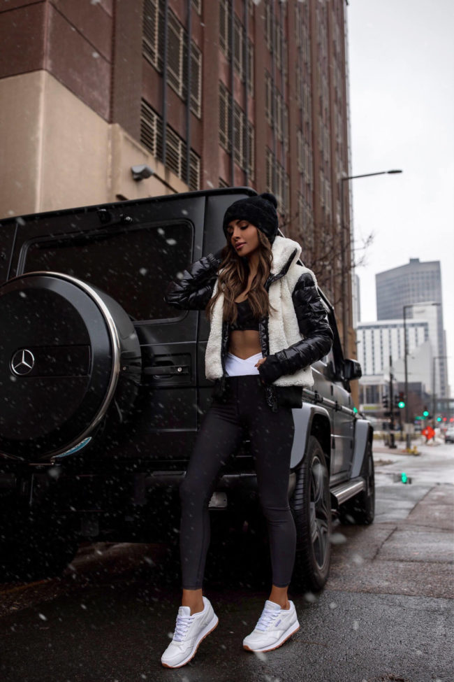 fashion blogger wearing a work out and fleece puffer jacket from bloomingdales