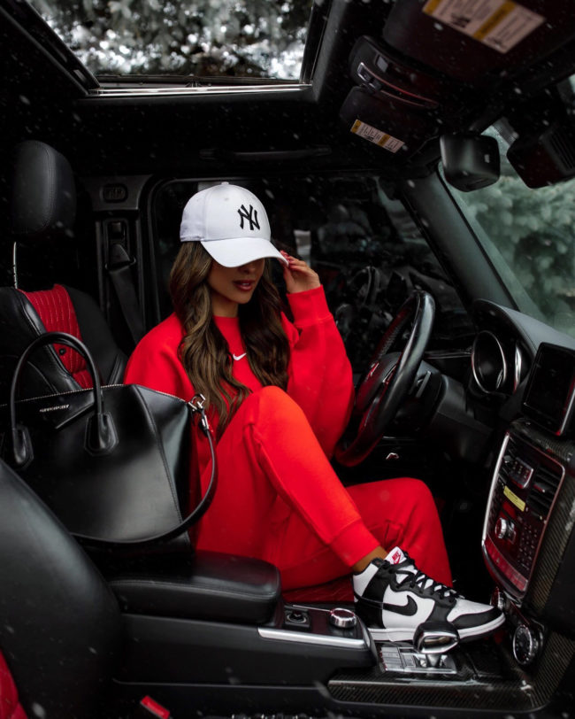 fashion blogger mia mia mine wearing a red nike sweatsuit