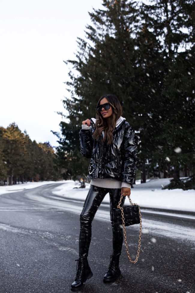 fashion blogger mia mia mine wearing a puffer jacket and patent leather leggings from walmart