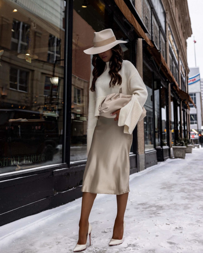 fashion blogger mia mia mine wearing a silk dress and white sweater from karen millen
