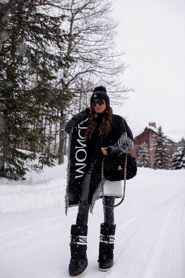 fashion blogger mia mia mine wearing moon boots and a moncler poncho puffer jacket