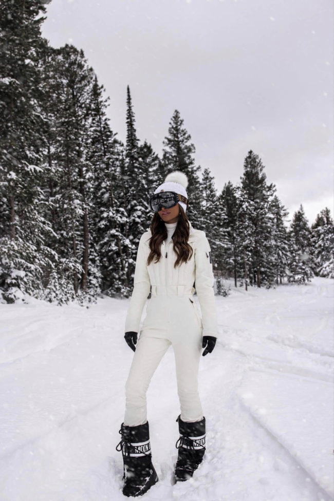 mia mia mine wearing a perfect moment white ski suit and moon boots in jackson hole