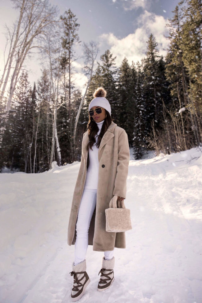 fashion blogger mia mia mine wearing a neutral outfit with shearling snow boots from saks off 5th