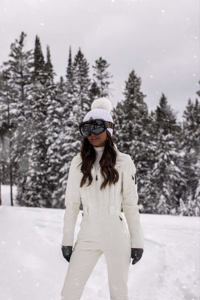 fashion blogger mia mia mine wearing a white ski suit by perfect moment