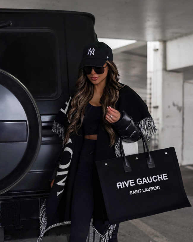 fashion blogger wearing a black rive gauche tote from mytheresa