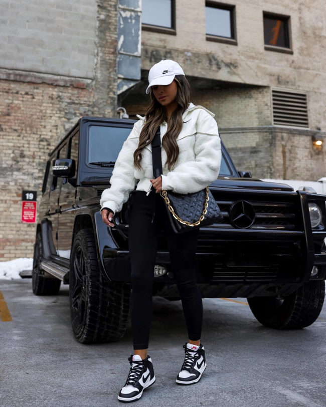 fashion blogger mia mia mine wearing black and white nike dunk high sneakers