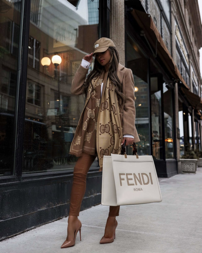 fashion blogger wearing a white fendi sunshine tote and a gucci scarf