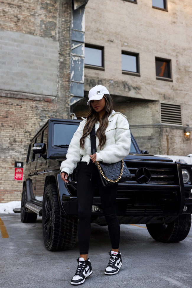 fashion blogger mia mia mine wearing black and white nike dunk high sneakers