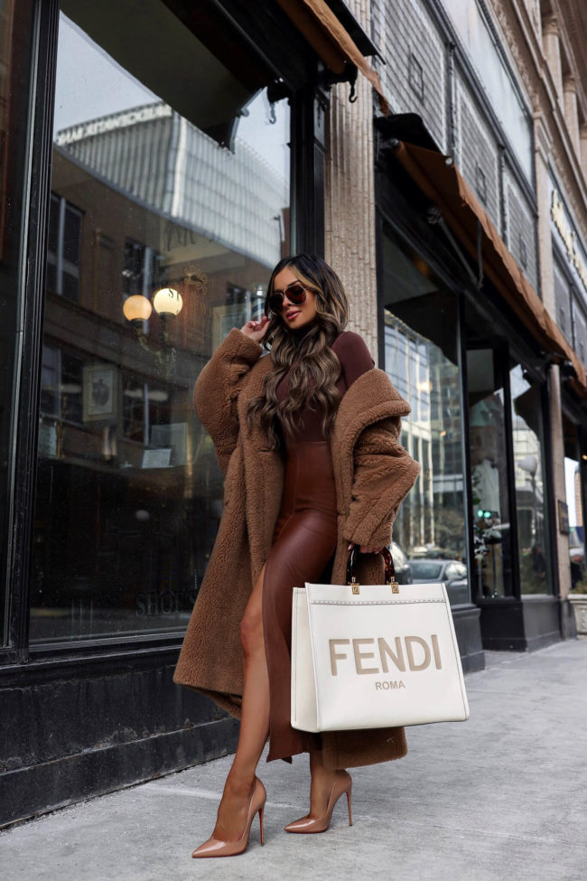 fashion blogger mia mia mine wearing a teddy bear coat and fendi sunshine tote from nordstrom