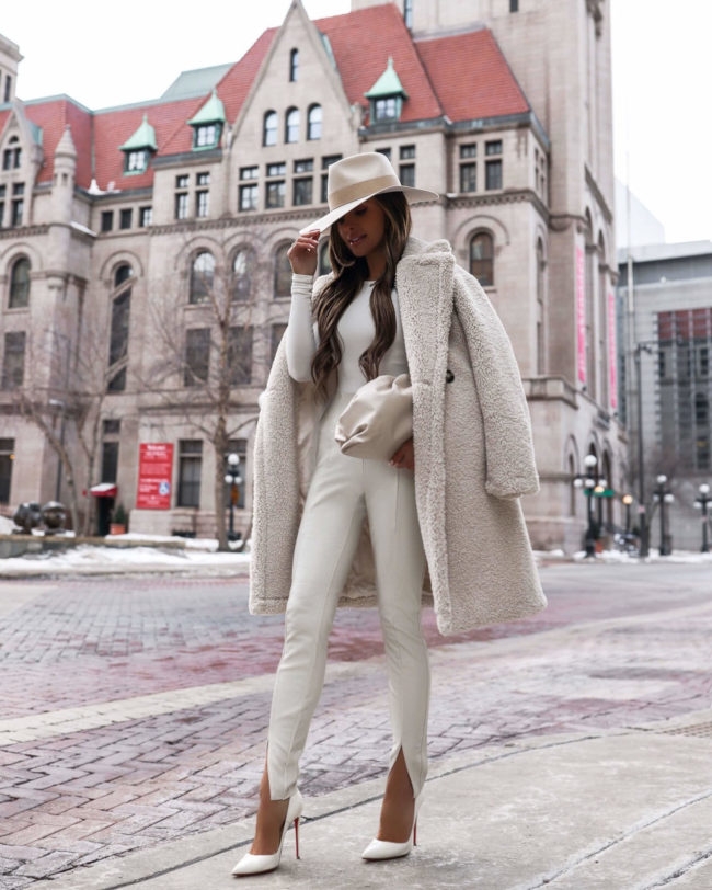 fashion blogger mia mia mine wearing a white winter outfit with white leather leggings from nordstrom