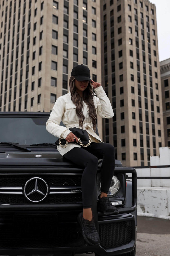 fashion blogger mia mia mine wearing a white utility jacket and leggings from walmart
