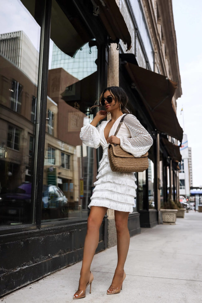 fashion blogger mia mia mine wearing a white fringe patbo dress from saks
