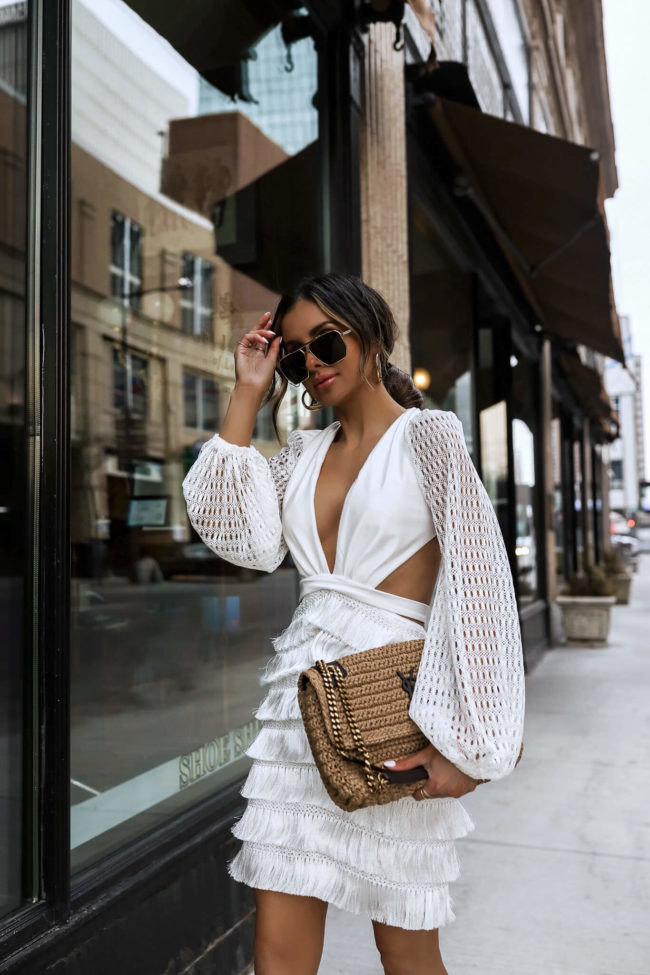 fashion blogger mia mia mine wearing a white patbo dress and saint laurent raffia bag from saks