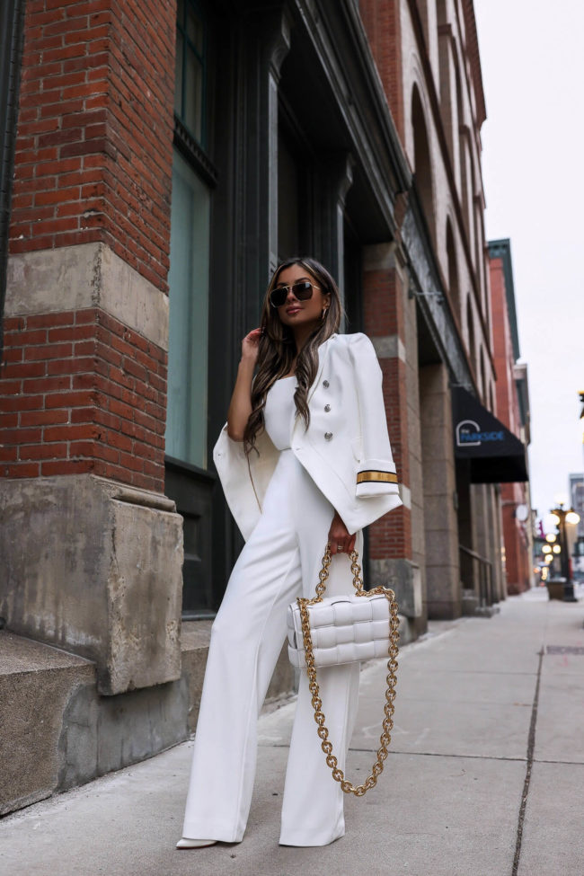 fashion blogger mia mia mine wearing a white jumpsuit from whbm