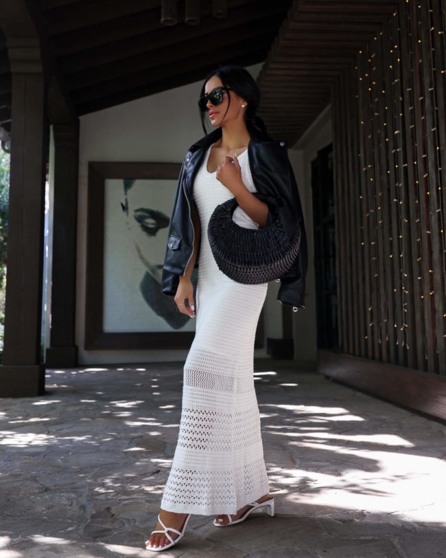 fashion blogger mia mia mine wearing a white crochet dress by scoop and a leather jacket