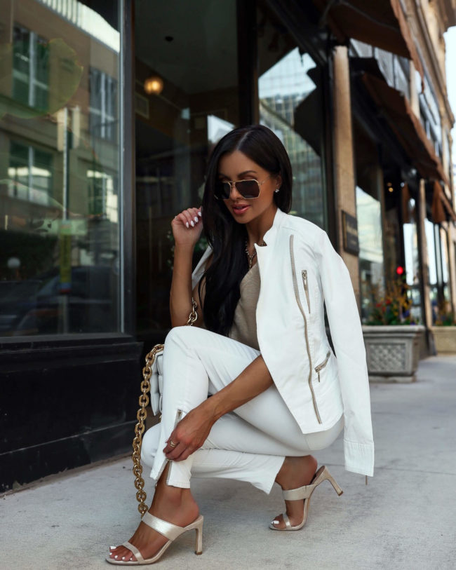 fashion blogger mia mia mine wearing a white moto jacket from whbm