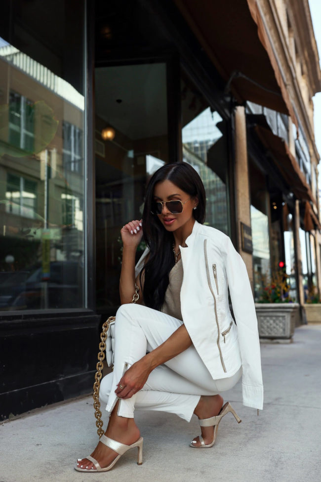 fashion blogger mia mia mine wearing a white moto jacket from whbm