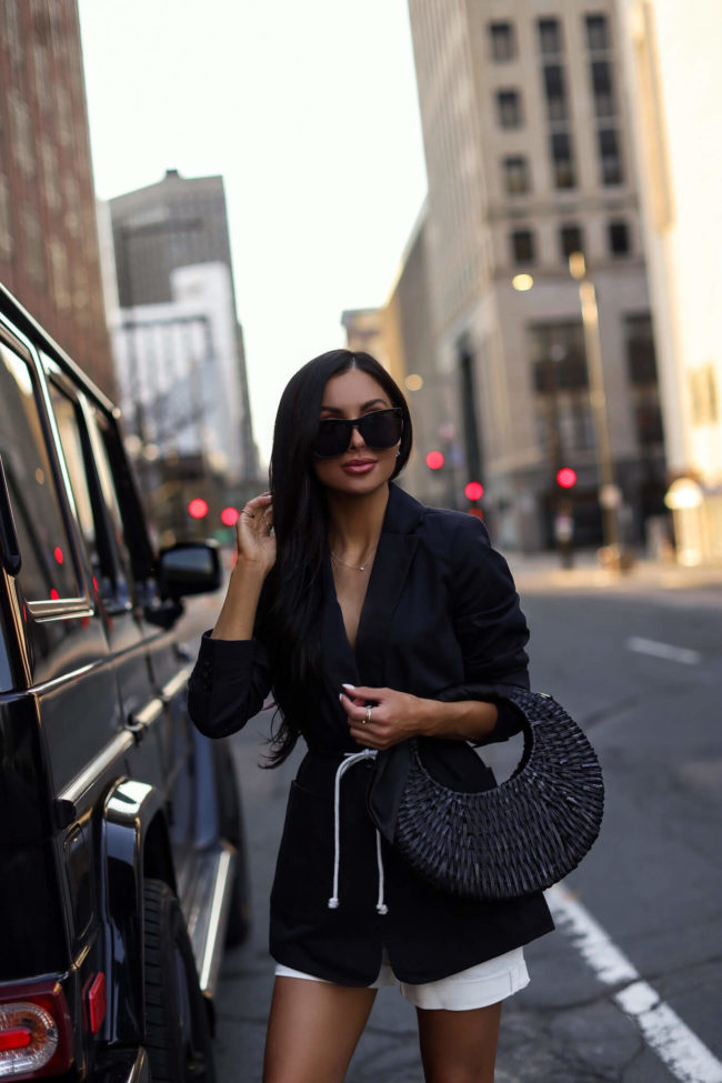fashion blogger mia mia mine wearing a black straw bag