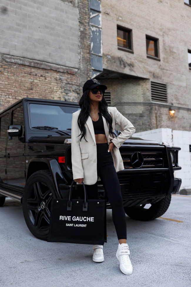 fashion blogger mia mia mine wearing white celine high top sneakers and a black knit set from amazon