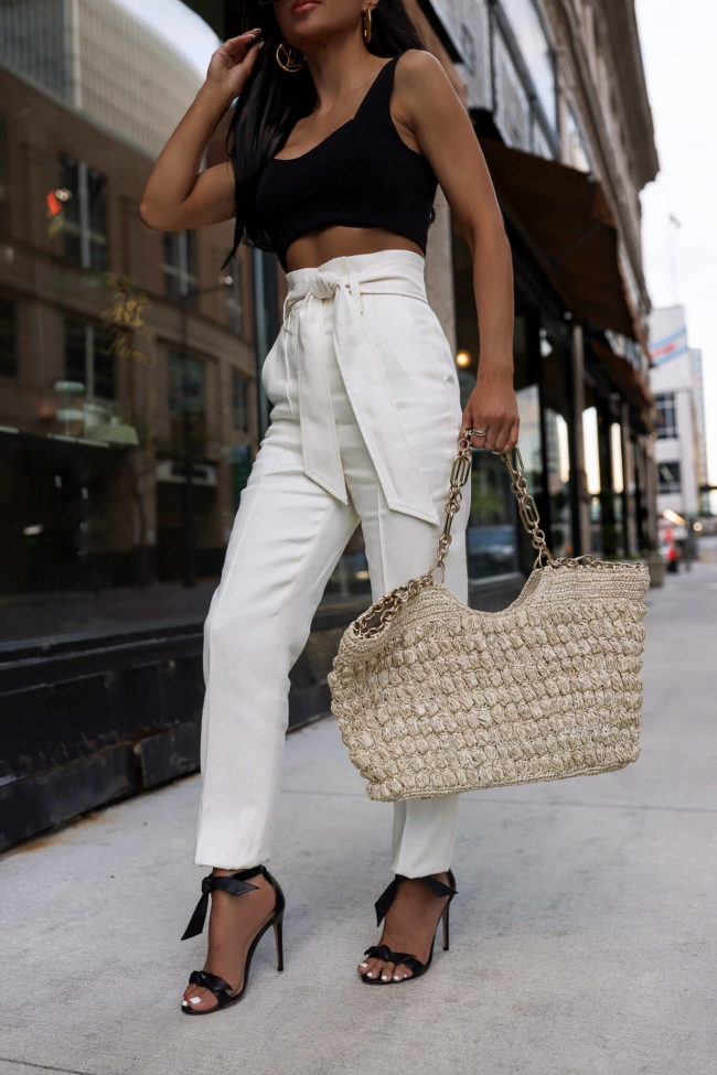 fashion blogger mia mia mine wearing a cult gaia straw tote bag from saks