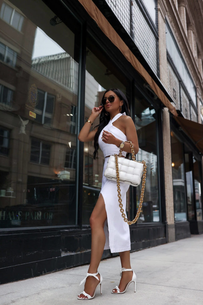 fashion blogger mia mia mine wearing a white linen set and a white bottega veneta the chain cassette bag