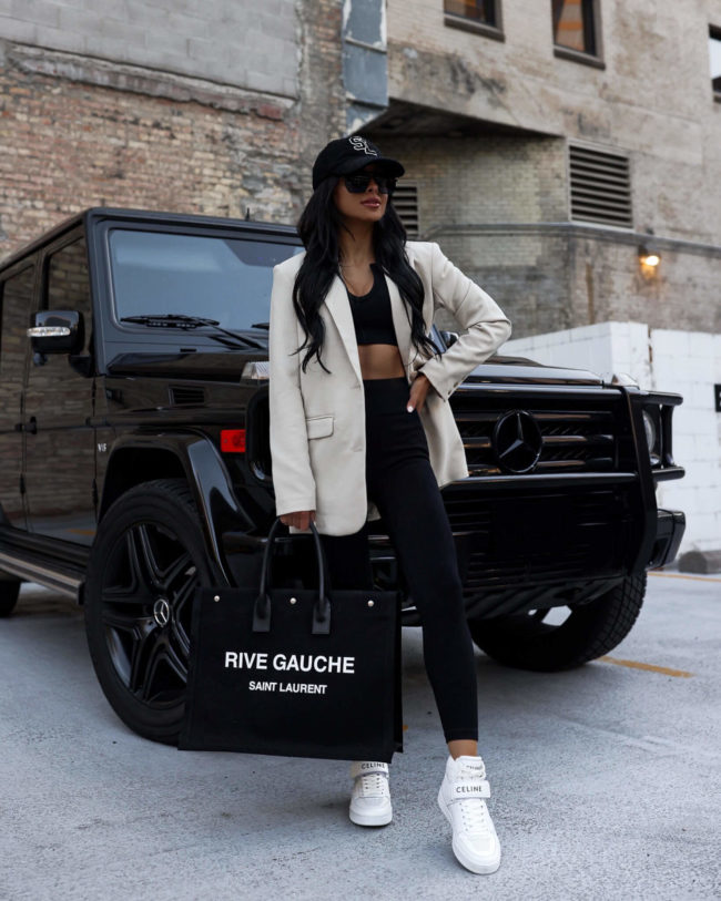 fashion blogger mia mia mine wearing white celine high top sneakers and a black knit set from amazon