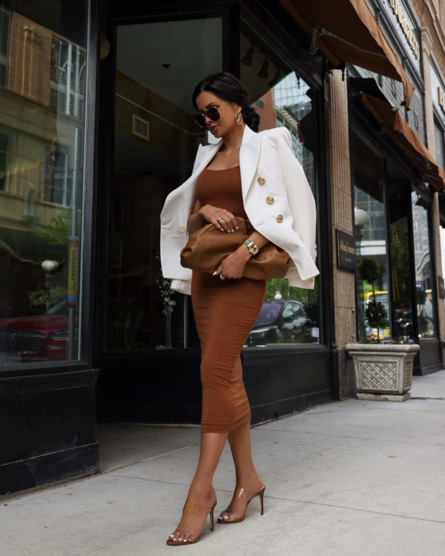 brunette woman wearing a white balmain blazer and dress for summer