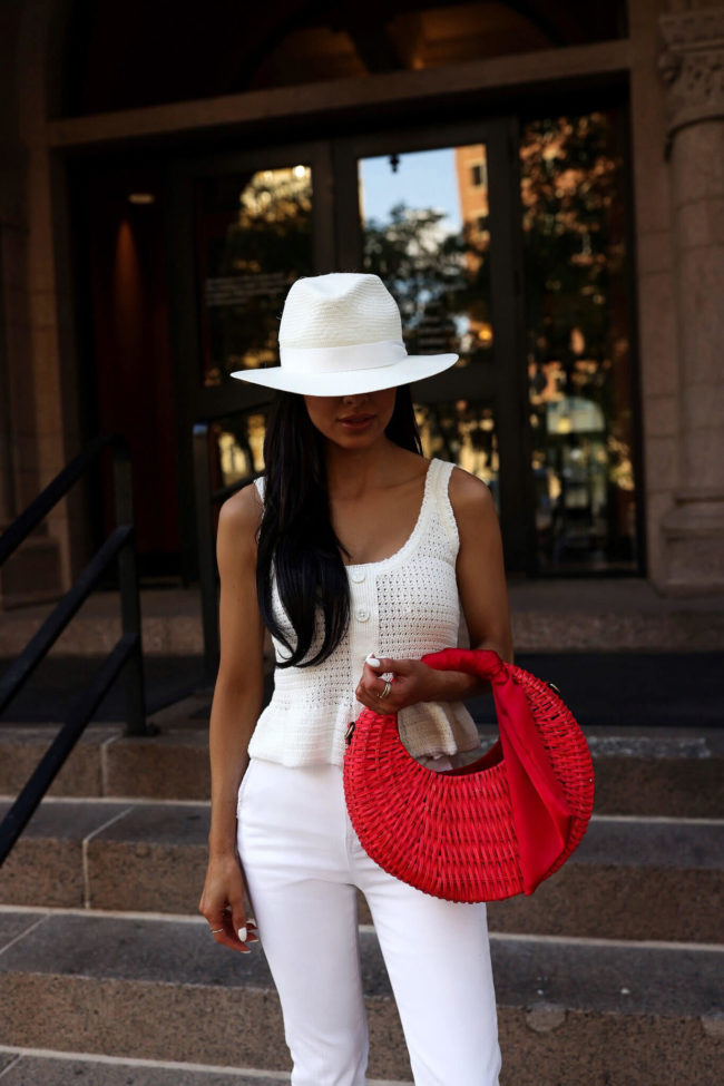 fashion blogger mia mia mine wearing an all white outfit with pops of red for summer